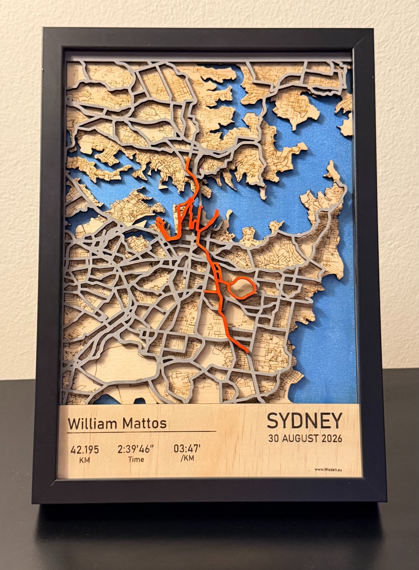 Finished laser-cut wooden map frame of the same cycling route